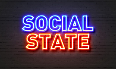 Social state neon sign on brick wall background.