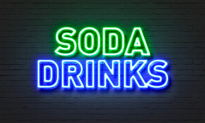 Soda drinks neon sign on brick wall background.