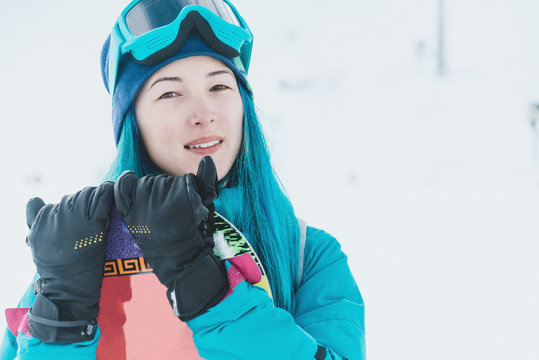 Girl snowboarder on ski resort