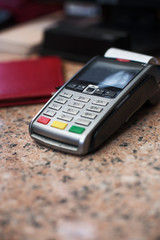 Close up of Credit Card Reader and Cash Register on background of Retail Shelves