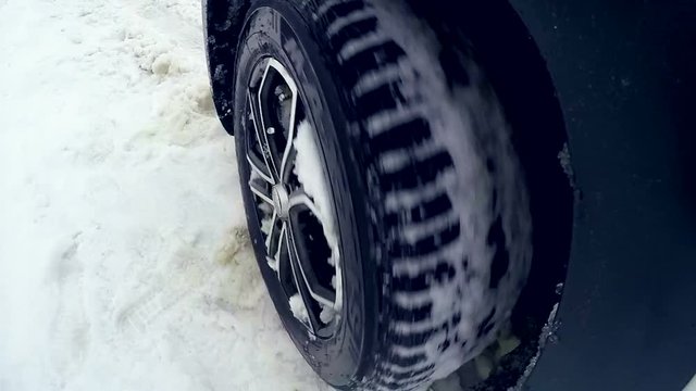 Tires, wheels driving through heavy snow. Slow motion. On board camera. HD