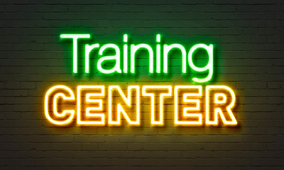 Training center neon sign on brick wall background.