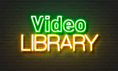 Video library  neon sign on brick wall background.