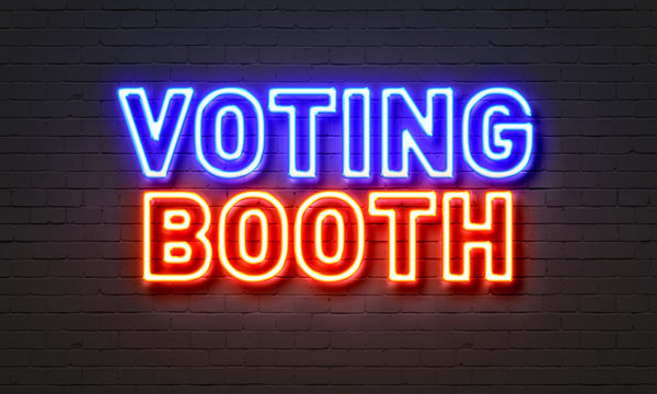 Voting booth neon sign on brick wall background.