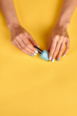Obraz na płótnie Canvas Blue manicure with nail polish.