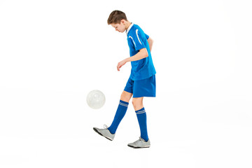 Young boy with soccer ball doing flying kick