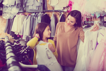 Family choosing dress in shop