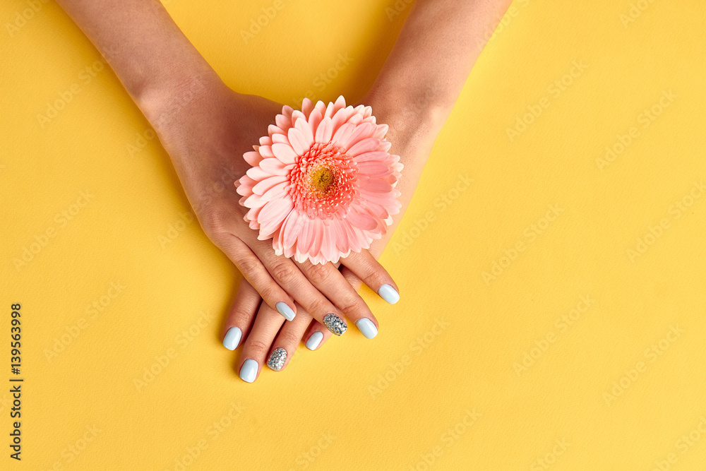 Wall mural beautiful nails with blue manicure. beauty salon.