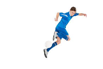 Fototapeta na wymiar Young boy with soccer ball doing flying kick