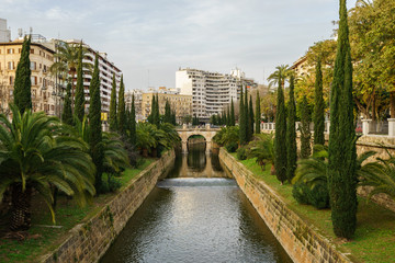 bridge on a canal in a mediterranean park