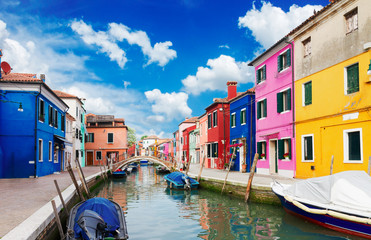 Fototapeta na wymiar multicolored houses over canal with boats, street of Burano island, Venice, Italy