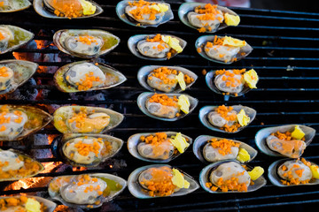 Grilled mussels topped with butter