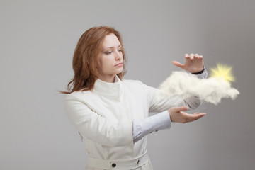 Woman with cloud and sun. Concept on the topic of computer cloud services.