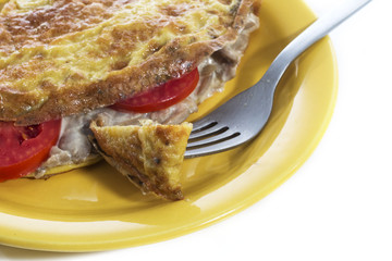 Omelet on a colored plate over white background