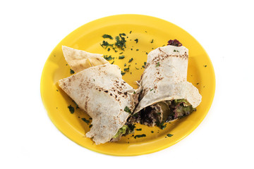 Delicious Wrap Sanduich, a snack made with healthy food on a yellow plate isolated on white background