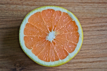 Closeup of a grapefruit half on a wooden table