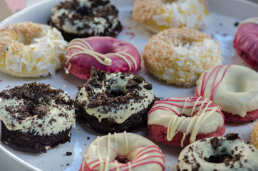 Assorted multycolored donuts for sale at street market