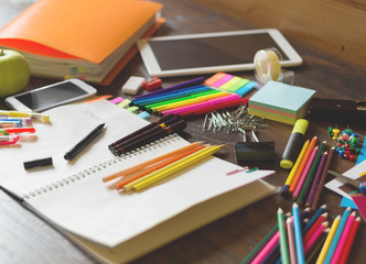 Colorful assortment of school supplies on table. Selective focus and small depth of field.