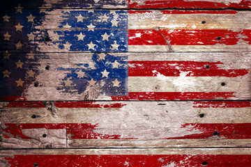 damaged grungy USA flag, stars and stripes on weathered wooden planks