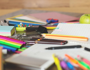 Colorful assortment of school supplies on table. Selective focus and small depth of field.