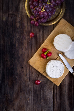 Cheese with white mold, grapes and radish