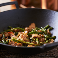 chinese string bean chicken in cast iron wok