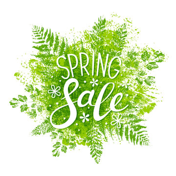 Spring sale message on green leaves background