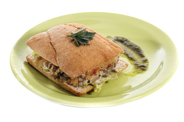Healthy chicken and mushroom sandwich on green plate over white background