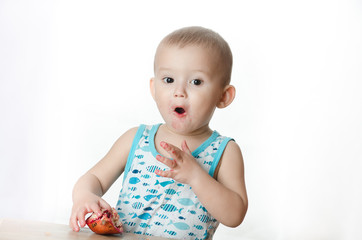 Fototapeta premium A child eating a pomegranate