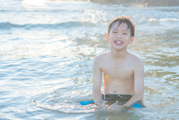 Young asian boy playing on the beach © gamelover