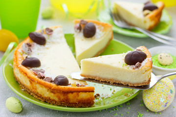 Easter cake cheesecake decorated with chocolate candy eggs