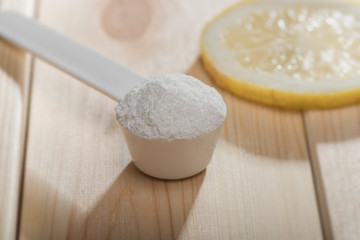 Sport supplement or vitamin with a lemon slice. Sport nutrition concept.