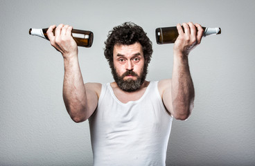 Fototapeta na wymiar Weightlifting with Beer bottles, Bearded Beer Man, Looking very tired