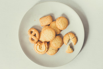 Butter Cookies in white ceramic dish on  white wood, background with copy space. 
