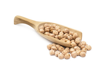 Wooden spoon with chick peas and more chickpeas next to it on a white background