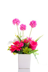Artificial flower in pot over white background