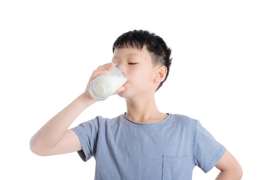 Young Asian Boy Drinking Milk Over White Background