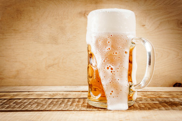 delicious golden beer on old wooden table