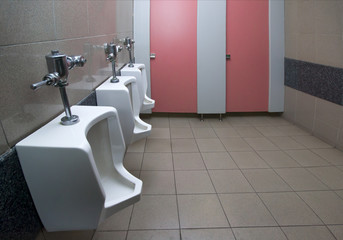 Tiles wall in the toilet of man with toilet view by urinals and small room , interior at the toilet...