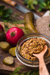 Mustard with seed in the glass bowl on the kitchen table
