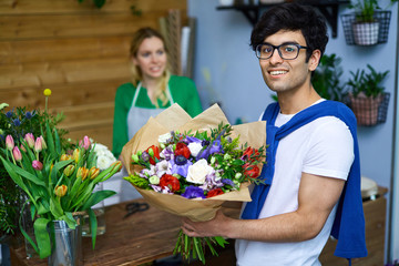 Happy guy bought fresh flowers for his girlfriend