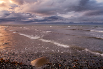 Sunset paint the sky and the sea. The sea of Okhotsk. The Koni Peninsula. Magadan oblast.