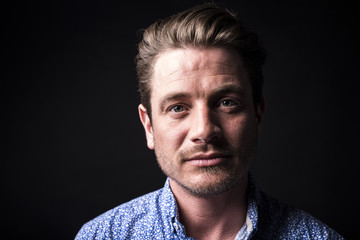 Obraz premium Closeup portrait of confident man on black background.