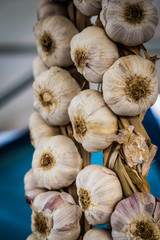 Organic garlic hanging on a farmer's market stall