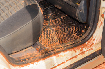 Dirty car interior with sand and mud everywhere