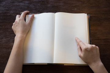 woman hands point to blank space  of the book