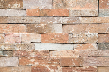 Brown stone wall tiles texture.wall pattern design or abstract background.