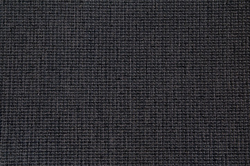 Closeup black color synthetic fabrics texture. Pattern design or polyester material abstract background.