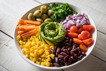 Vegan Buddha bowl. Mixed vegetable salad. Healthy meal concept. White wooden background.