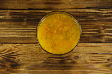 Soup in glass bowl on wooden table